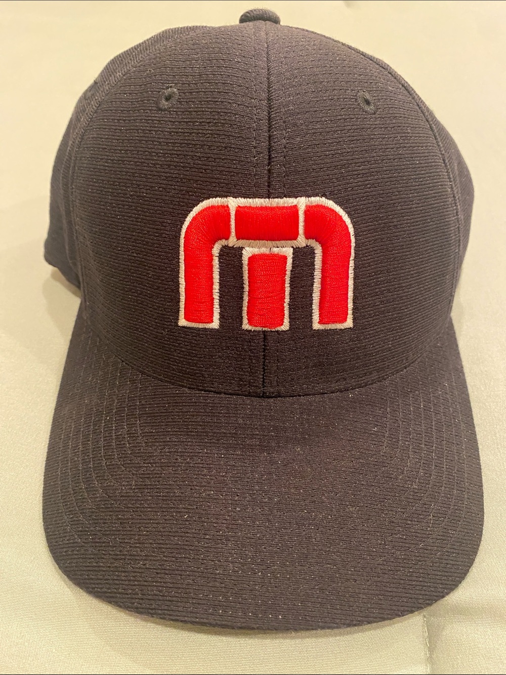 Travis Mathew Black Cap with Red & White Embroidered Logo